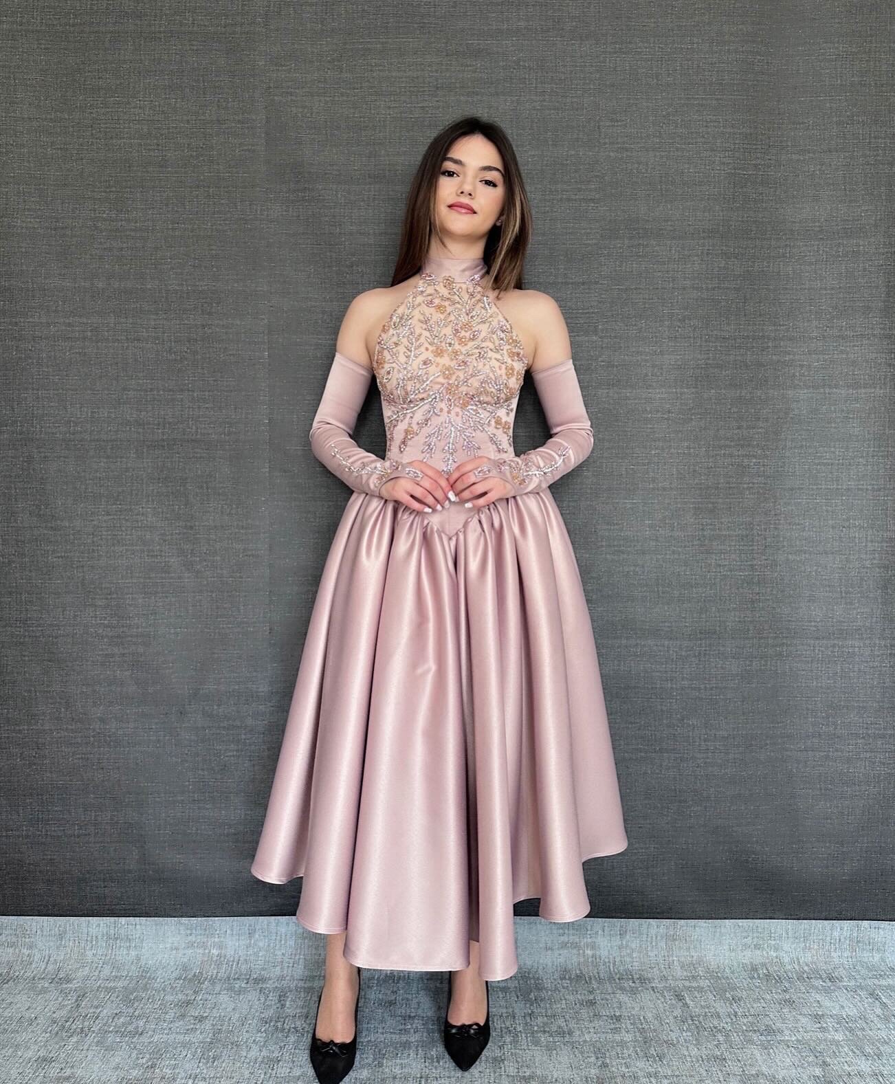 Model in a pale pink beaded gown with a full skirt